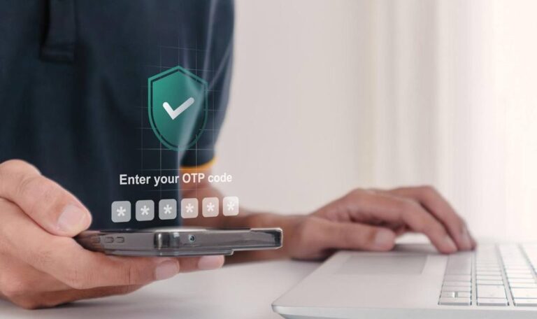 Person entering a test case for OTP verification code on a smartphone at a laptop